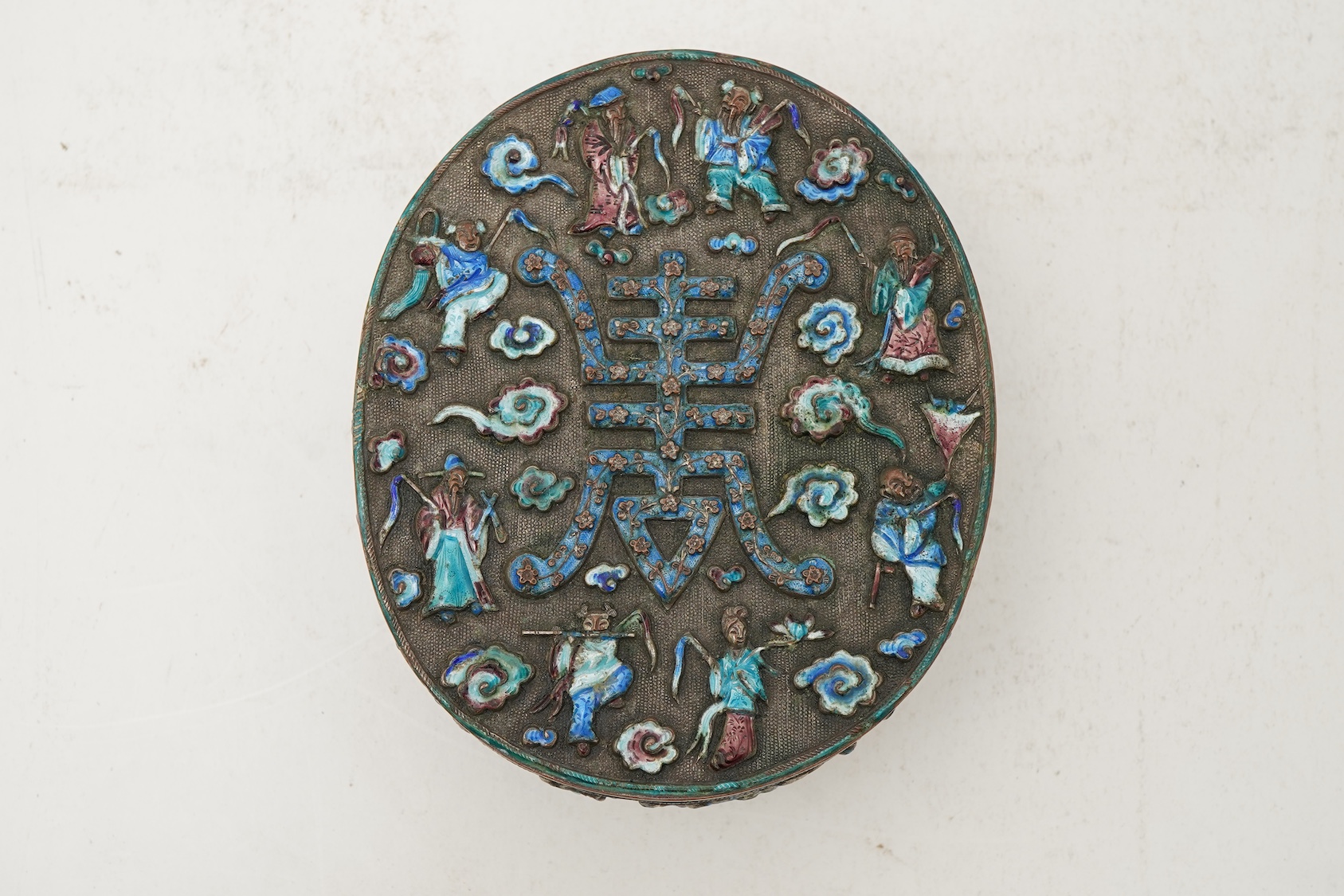 A Chinese silver plated and enamel ‘eight immortals’ oval box, late 19th century